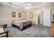 Spacious main bedroom features a tray ceiling, carpeted floors, and neutral decor at 7008 Glen Valley Way, Fairburn, GA 30213