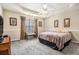 Spacious main bedroom features a tray ceiling, carpeted floors, and neutral decor at 7008 Glen Valley Way, Fairburn, GA 30213