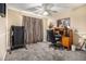 Bedroom featuring a home office setup, carpet, and a ceiling fan at 7008 Glen Valley Way, Fairburn, GA 30213