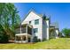 Back exterior of home with screen porch, lower patio, black fence, and well manicured lawn at 2235 Birchtree Way, Marietta, GA 30062