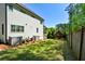 Spacious backyard with green lawn, playset, wood fence, and well maintained landscaping at 2235 Birchtree Way, Marietta, GA 30062