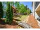 Landscaped backyard featuring a playset, small foot bridge, and mature trees at 2235 Birchtree Way, Marietta, GA 30062