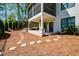 Backyard featuring patio and playset with mature trees, a stone pathway and a white brick house at 2235 Birchtree Way, Marietta, GA 30062