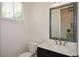 Elegant powder room featuring a framed mirror, modern fixtures, and a sleek vanity with ample counter space at 2235 Birchtree Way, Marietta, GA 30062