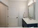 Bathroom featuring white door, dark blue vanity with silver hardware, and rectangular framed mirror at 2235 Birchtree Way, Marietta, GA 30062