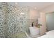 Modern bathroom featuring a glass-enclosed shower, freestanding tub, and contemporary mosaic tiling at 2235 Birchtree Way, Marietta, GA 30062