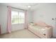 Bright bedroom with a pink daybed, large window with curtains, and ceiling fan at 2235 Birchtree Way, Marietta, GA 30062