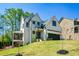 Exterior view of the home featuring manicured lawn, screened porch, and two car garage at 2235 Birchtree Way, Marietta, GA 30062