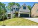 Charming two-story home with a black two-car garage door and a well-manicured lawn at 2235 Birchtree Way, Marietta, GA 30062