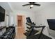 Home gym featuring black treadmill, dumbbells, mounted TV, and stairway access at 2235 Birchtree Way, Marietta, GA 30062