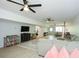 Spacious living room with hardwood floors, sectional sofa, flat screen TV, and ceiling fans at 2235 Birchtree Way, Marietta, GA 30062