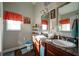 Bright bathroom features a double sink vanity with dark wood cabinets and tasteful decor at 504 Cole Creek Dr, Dallas, GA 30157