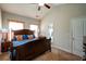Spacious bedroom featuring a large bed, windows with orange curtains, and neutral carpet at 504 Cole Creek Dr, Dallas, GA 30157
