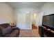 Bedroom featuring a brown leather sofa, and neutral-toned walls and carpet at 504 Cole Creek Dr, Dallas, GA 30157