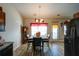 Bright dining area with hardwood floors, a charming window, and modern appliances at 504 Cole Creek Dr, Dallas, GA 30157