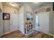 Cozy entryway featuring a decorative display shelf, light wood flooring, and a white front door at 504 Cole Creek Dr, Dallas, GA 30157