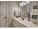 Bathroom with a white vanity, decorative mirror, and modern lighting fixtures at 5327 Saville Nw Dr, Acworth, GA 30101