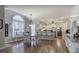 Large open kitchen with dining area, featuring an abundance of natural light, white cabinets and hardwood floors at 5327 Saville Nw Dr, Acworth, GA 30101