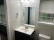 Simple bathroom with a mirror, sink, and toilet, featuring clean and neutral finishes at 5755 Belmont Ridge Cir, Lithonia, GA 30038