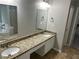 Bathroom with double vanity, granite countertop, mirrors, and tile flooring at 5755 Belmont Ridge Cir, Lithonia, GA 30038