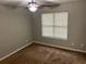 Neutral bedroom with carpet, ceiling fan, and a window offering natural light at 5755 Belmont Ridge Cir, Lithonia, GA 30038