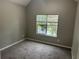 Neutral bedroom featuring carpet, a window with blinds, and natural lighting at 5755 Belmont Ridge Cir, Lithonia, GA 30038