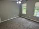 Bedroom with carpet, ceiling fan, and windows providing natural light and views at 5755 Belmont Ridge Cir, Lithonia, GA 30038