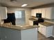 A well-equipped kitchen featuring granite counters, stainless appliances, and white cabinets at 5755 Belmont Ridge Cir, Lithonia, GA 30038