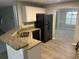 Bright kitchen with granite counters, stainless appliances, a breakfast bar, and views to the dining room at 5755 Belmont Ridge Cir, Lithonia, GA 30038