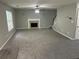 Spacious living room features a fireplace, ceiling fan, and carpet flooring throughout at 5755 Belmont Ridge Cir, Lithonia, GA 30038