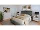Comfortable bedroom with a padded headboard, soft bedding, stylish nightstands, and ample natural light at 209 14Th Ne St # 109, Atlanta, GA 30309