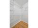 Walk-in closet features built-in storage shelves and hardwood floor at 209 14Th Ne St # 109, Atlanta, GA 30309
