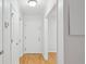 Bright hallway with neutral paint, white trim and doors, and attractive wood flooring at 209 14Th Ne St # 109, Atlanta, GA 30309