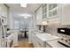 Well-equipped kitchen with white cabinets, a farmhouse sink, and modern appliances at 209 14Th Ne St # 109, Atlanta, GA 30309