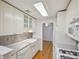 Bright kitchen with white cabinets, tile backsplash, stainless steel appliances, and hardwood floors at 209 14Th Ne St # 109, Atlanta, GA 30309
