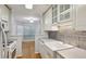 Charming kitchen featuring white cabinets, stainless steel appliances, and a farm sink at 209 14Th Ne St # 109, Atlanta, GA 30309