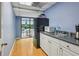 A cozy kitchenette features white cabinets, stainless steel sink, and a view of the pool at 209 14Th Ne St # 109, Atlanta, GA 30309