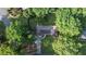 Aerial view of wooded neighborhood showing roof of home with mature trees at 23 Hunting Creek Dr, Marietta, GA 30068