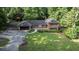 Brick home featuring an attached garage and large grassy front yard with mature trees at 23 Hunting Creek Dr, Marietta, GA 30068
