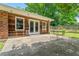 Backyard of home featuring wood-lined house, garden and patio with dining set at 23 Hunting Creek Dr, Marietta, GA 30068