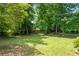 A serene backyard with mature trees, perfect for relaxation and outdoor activities at 23 Hunting Creek Dr, Marietta, GA 30068