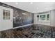 Finished basement with dark tile flooring, large blackboard, and exterior door and windows at 23 Hunting Creek Dr, Marietta, GA 30068