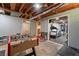 Basement rec room featuring gym beyond and a foosball table at 23 Hunting Creek Dr, Marietta, GA 30068