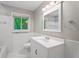 Bright bathroom with a white vanity, tiled shower, and nature views through a window at 23 Hunting Creek Dr, Marietta, GA 30068