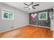 Spacious bedroom features hardwood floors, neutral walls, ceiling fan, closet, and natural light at 23 Hunting Creek Dr, Marietta, GA 30068