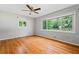 Bright bedroom with hardwood floors, a ceiling fan, and large windows with green views at 23 Hunting Creek Dr, Marietta, GA 30068