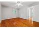 Bright bedroom with hardwood floors, a ceiling fan, and a view of the greenery outside at 23 Hunting Creek Dr, Marietta, GA 30068