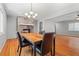 Cozy dining room featuring a fireplace, modern chandelier, and hardwood floors at 23 Hunting Creek Dr, Marietta, GA 30068