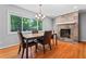 Charming dining room featuring a stone fireplace and a large window showcasing backyard at 23 Hunting Creek Dr, Marietta, GA 30068