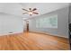 Spacious living room featuring hardwood floors, a ceiling fan, and a large window at 23 Hunting Creek Dr, Marietta, GA 30068